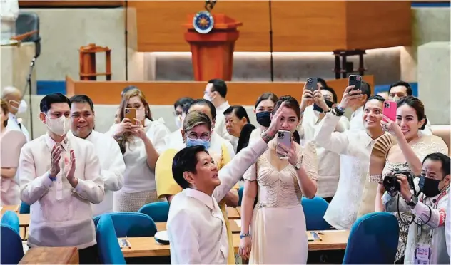  ?? Associated Press ?? ±
Ferdinand Marcos (centre) waves as he arrives for his first State of the Nation address in Quezon city on Monday.