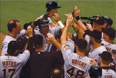  ?? JOSE CARLOS FAJARDO — STAFF FILE ?? The Giants’ Barry Bonds, center, is mobbed by teammates after hitting his 714th career home run May 20, 2006, to tie Babe Ruth for second place on the all-time home run list.