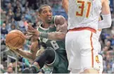  ?? HOFFMAN / MILWAUKEE JOURNAL SENTINEL MARK ?? Bucks guard Eric Bledsoe looks to make a pass under the basket Saturday night.