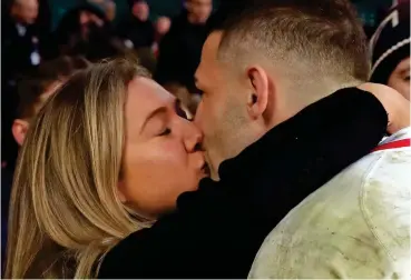  ??  ?? So proud: Jonny May gets a congratula­tory kiss from his wife after yesterday’s match