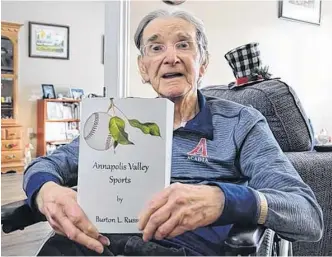  ?? FILE ?? Sports historian and author Burton Russell, of Kentville, is shown with a copy of his 14th book, Annapolis Valley Sports, which was published in December 2021. Russell passed away on April 26.