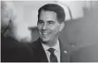  ?? ASSOCIATED PRESS ?? Gov. Scott Walker greets visitors in the Assembly Chamber prior to delivering his state budget address last week in Madison.