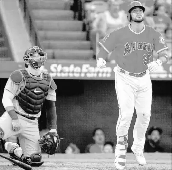  ?? Kyusung Gong The Associated Press ?? Angels rookie Francisco Arcia and Mariners catcher Mike Zunino watch Arcia’s threerun homer in Los Angeles’ 11-5 win Saturday. He totaled three hits and six RBIs.