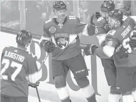  ?? JIM RASSOL/SUN SENTINEL ?? Panthers center Aleksander Barkov (16) celebrates a goal in the second period Thursday night with Evgenii Dadonov (63), Mike Matheson (19) and Nick Bjugstad (27).