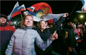  ??  ?? People celebrate the anniversar­y of Russia’s annexation of Crimea in Sevastopol. Moscow’s takeover led to a diplomatic crisis with the U.S. and American sanctions. CRIMEA AND PUNISHMENT: