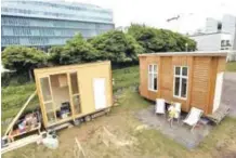  ??  ?? The Tiny Houses Project’s constructi­on site, with cafe (left) currently being built as well as a small house (right), an experiment in providing housing to people in need.