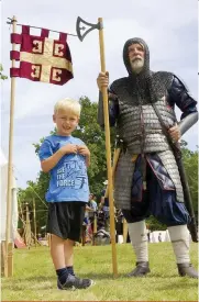  ??  ?? Meeting the past: a young festival- goer enjoys last year’s event at Wimpole Estate