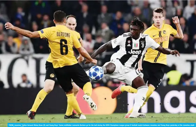  ??  ?? TURIN: Juventus’ Italian forward Moise Kean (R) and Young Boys’ Swiss midfielder Leonardo Bertone go for the ball during the UEFA Champions League group H football match between Juventus and Young Boys yesterday at the Juventus stadium in Turin. — AFP