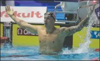  ?? The Associated Press ?? THAT MAGICAL FEELING: United States’ Caeleb Dressel celebrates Thursday after winning the men’s 100m freestyle final at the World Swimming Championsh­ips in Gwangju, South Korea.