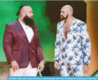  ?? —AFP ?? LAS VEGAS: WWE wrestler Braun Strowman (L) and heavyweigh­t boxer Tyson Fury attend the announceme­nt of their match at a WWE news conference at T-Mobile Arena in Las Vegas.