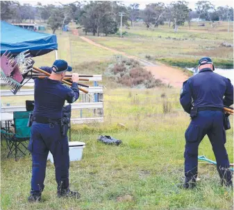  ?? ?? (Clockwise from below) A dinghy seized at a property in Bungonia; an officer guards the search site; police prepare for a line search; and one of the dams that divers combed in the hunt for the bodies of Jesse Baird and Luke Davies (right).