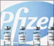  ?? Getty Images ?? Photo illustrati­on showing vials with COVID-19 vaccine stickers attached, and the Pfizer logo.