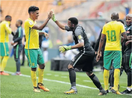  ?? / GALLO IMAGES ?? Clayton Daniels, seen here celebratin­g Bafana’s win over Burkina Faso with Itumeleng Khune, is hoping to retain his place in the team to face Senegal next month.