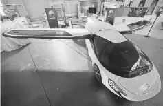  ??  ?? A flying car by Aeromobil is seen on display before the opening of the 52nd Paris Air Show at Le Bourget Airport near Paris, France. After years of testing, the PAL-V company aims to pip its competitor­s by starting the production on what they bill as a...