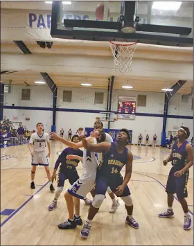  ?? Terrance Armstard/News-Times ?? Block out: Junction City's Jerrodney Tubbs (14) looks to snare a rebound during the Dragons’ 8-2A contest against Parkers Chapel. Junction City opens postseason play tonight needing a win to advance to the regional tournament.