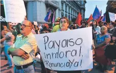 ?? FOTO: AFP ?? Un grupo de manifestan­tes protestaro­n ayer pidiendo la renuncia de Morales, a la vez que patentaron su apoyo a la Fiscalía y la Cicig.