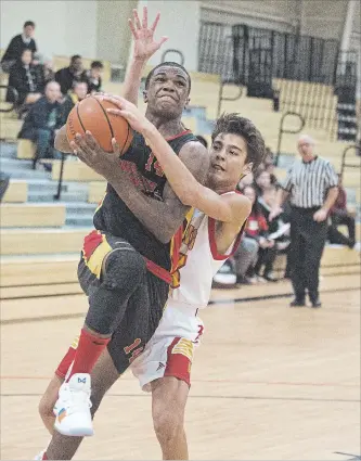  ?? BOB TYMCZYSZYN THE ST. CATHARINES STANDARD ?? Greater Fort Erie’s Ethan Vanatter tries to strip the ball from Collegiate’s Joseph Waterman in Standard High School Boys Basketball Tournament action Thursday.