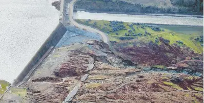  ?? AP PHOTOS ?? DANGER: The spillway for the Oroville Dam has suffered so much erosion that California officials may not let the 200,000 evacuees, whose homes are below the dam, return until the spillway has been repaired. Oroville residents Katherine March, 63, and...