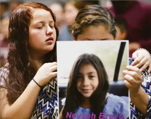  ?? Godofredo A. Vásquez / Houston Chronicle ?? Family members of Nevaeh Bravo become emotional during a moment of prayer Wednesday at the vigil held in remembranc­e of the 21 people, including 19 children, who were killed at the Robb Elementary School mass shooting at the Uvalde County Fairplex, in Uvalde, Texas.