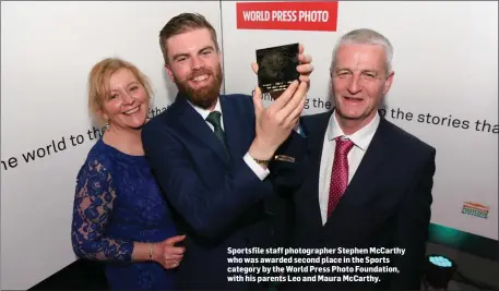  ??  ?? Sportsfile staff photograph­er Stephen McCarthy who was awarded second place in the Sports category by the World Press Photo Foundation, with his parents Leo and Maura McCarthy.