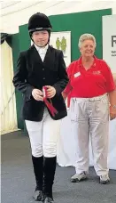  ??  ?? Ellis Holdaway being presented his rosette for first in the dressage.