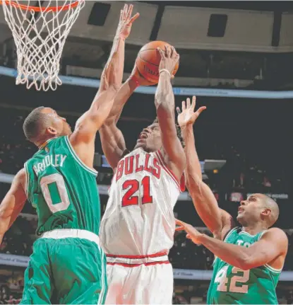  ??  ?? Jimmy Butler, who had 24 points and seven rebounds, goes to the basket against Celtics guard Avery Bradley. | GARY DINEEN/ GETTY IMAGES