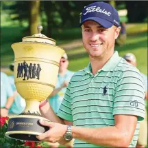  ?? The Associated Press ?? Justin Thomas holds the The Gary Player Cup trophy after winning the final round of the Bridgeston­e Invitation­al golf tournament at Firestone Country Club, Sunday in Akron, Ohio.