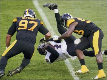  ?? GENE J. PUSKAR — THE ASSOCIATED PRESS ?? Ravens quarterbac­k Robert Griffin III flies is upended by Steelers defensive end Cameron Heyward and inside linebacker Vince Williams in the first half Dec. 2 in Pittsburgh.