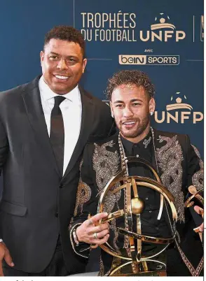  ??  ?? Best of the lot: Paris St Germain’s forward Neymar (right) poses with his trophy with former Brazilian internatio­nal Ronaldo on Sunday. — AFP