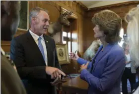  ?? PHOTOS BY MOLLY RILEY — THE ASSOCIATED PRESS ?? Interior Secretary Ryan Zinke speaks with Sen. Lisa Murkowski, R-Alaska at the Interior Department in Washington, Wednesday, after signing an order lifting a moratorium on new coal leases on federal lands and a related order on coal royalties.