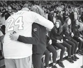  ?? Wally Skalij Los Angeles Times ?? LAKERS ASSISTANT coach Phil Handy hugs a member of Team Mamba, Gianna Bryant’s basketball team, at Staples Center during Friday’s tribute.