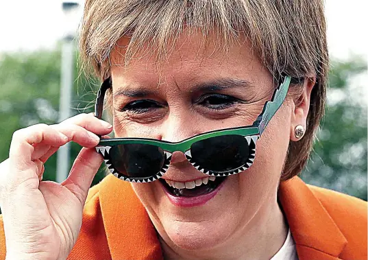  ??  ?? Rose tinted: Nicola Sturgeon, pictured on a visit to Glasgow yesterday, hopes to restart her drive for Scots independen­ce