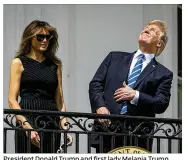  ?? AL DRAGO / THE NEW YORK TIMES ?? President Donald Trump and first lady Melania Trump view the solar eclipse Monday from the Truman balcony of the White House in Washington, D.C.