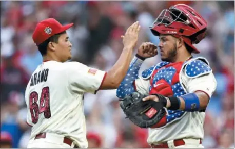  ?? DERIK HAMILTON — THE ASSOCIATED PRESS ?? The Phillies’ Victor Arano, left, celebrates with Jorge Alfaro after the team’s game against the Orioles on Wednesday.