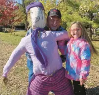  ?? ?? Jeff Novelli, of Frankfort, with his granddaugh­ter, Diem, after she made a scarecrow at the festival.