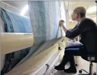  ?? AP PHOTO ?? In this Nov. 7 photo, textile conservato­r Kate Tarleton of Rochester, Mass., works to restore a portion of the 1848, “Grand Panorama of a Whaling Voyage Round the World,” at the New Bedford Whaling Museum in New Bedford, Mass. The artifact is believed...