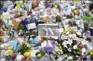  ?? KIRSTY O’CONNOR / PA ?? A photograph of member of Parliament David Amess is seen among the tribute near the Belfairs Methodist Church in Eastwood Road North, where Amess died after he was stabbed several times.