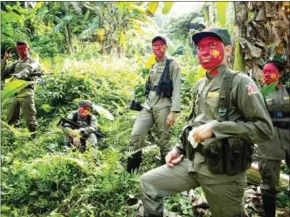  ?? NOEL CELIS/AFP ?? Guerrillas of the New People’s Army rest in the Sierra Madre mountain range, east of Manila, on July 30.