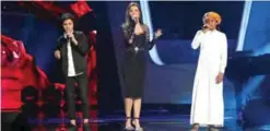  ??  ?? Lebanese singer and judge Nancy Ajram (center) sings with Lebanese George Assi (left) and Saudi Loujay Al-Masrahy (right) during season two of the “The Voice Kids: Ahla Sawt”.