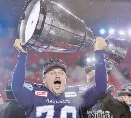  ?? PAUL CHIASSON/THE CANADIAN PRESS ?? Argonauts kicker Lirim Hajrullahu hoisted the Grey Cup after his field goal was the margin of victory in Toronto’s 27-24 win in Ottawa on Sunday.
