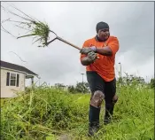  ?? CHRIS GRANGER THE TIMES-PICAYUNE/THE NEW ORLEANS ADVOCATE VIA AP ?? Hurricane Zeta winds make the grass that Teddy Johnson, 58, was cutting in New Orleans fly in the air on Wednesday.