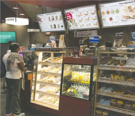  ?? CP FILES ?? Restaurant Brands Internatio­nal Inc’s biggest chain, Tim Hortons, was hit by fierce competitio­n from coffee houses and breakfast chains.