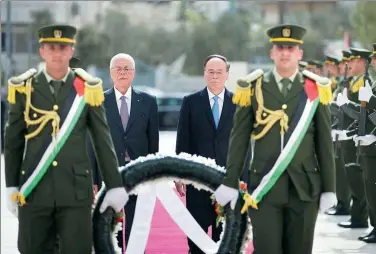  ?? FADI AROURI / REUTERS ?? Vice-President Wang Qishan and Tayeb Abdul Rahim, secretary-general of the Palestinia­n president’s office, visit the tomb of former Palestinia­n leader Yasser Arafat in Ramallah, Palestine, on Tuesday to lay a wreath.