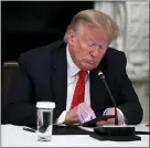  ?? ALEX BRANDON — THE ASSOCIATED PRESS FILE ?? In this June 18, 2020 file photo, President Donald Trump looks at his phone during a roundtable with governors on the reopening of America’s small businesses, in the State Dining Room of the White House in Washington.