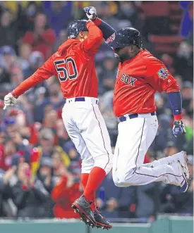  ??  ?? The Red Sox’ David Ortiz, right, celebrates with Mookie Betts.