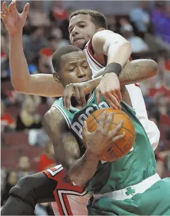  ?? Ap pHOtO ?? TAKING HOME A SERIES WIN: Terry Rozier grabs a rebound away from the Bulls’ Michael Carter-Williams during the Celtics’ clinching 105-83 victory in last night’s Game 6 in Chicago. The Celts face the Wizards beginning tomorrow at the Garden.