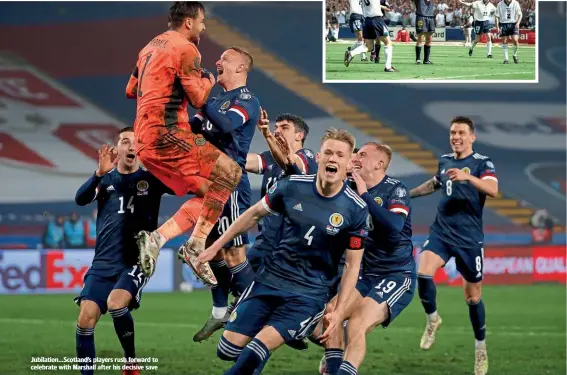  ??  ?? Jubilation…Scotland’s players rush forward to celebrate with Marshall after his decisive save