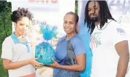  ??  ?? Heather Ferguson (centre), second place in the female WATA challenge at The Gleaner’s Fit 4 Life event in Forest Gardens, St Andrew. Presenting her with a Foska Oats and Blue Diamond Almond Milk gift basket is representa­tive Selena Prestwydge (left)...