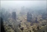  ?? NICK GIBLIN — DRONEBASE VIA AP ?? This aerial image shows a neighborho­od that was destroyed by a wildfire in Santa Rosa Tuesday. Newly homeless residents of California wine country took stock of their shattered lives Tuesday, a day after deadly wildfires destroyed homes and businesses.