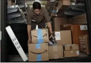  ?? LYNNE SLADKY - THE ASSOCIATED PRESS FILE PHOTO ?? In this July 17, 2018, file photo UPS employee Liz Perez unloads packages for delivery in Miami, Tuesday, July 17, 2018. Amazon’s “Prime Day” is back.